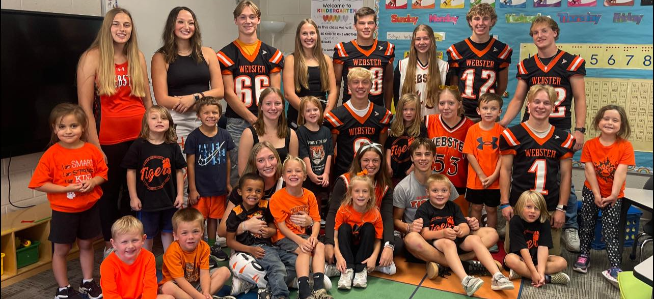 High school athletes with kindergarten students